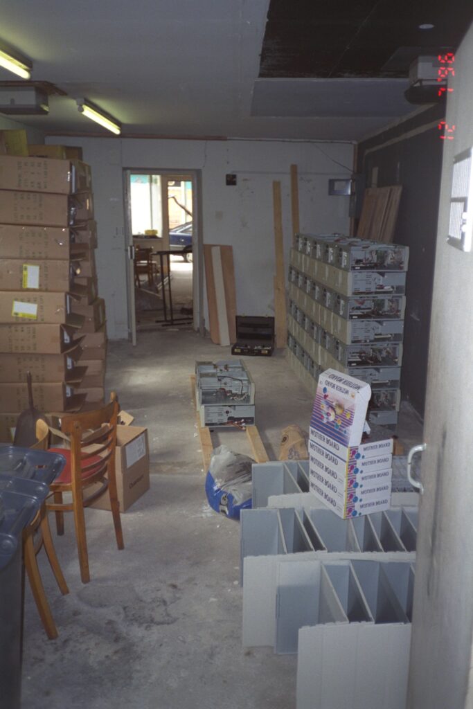 A workshop area show various partially assembled PC systems in a stack